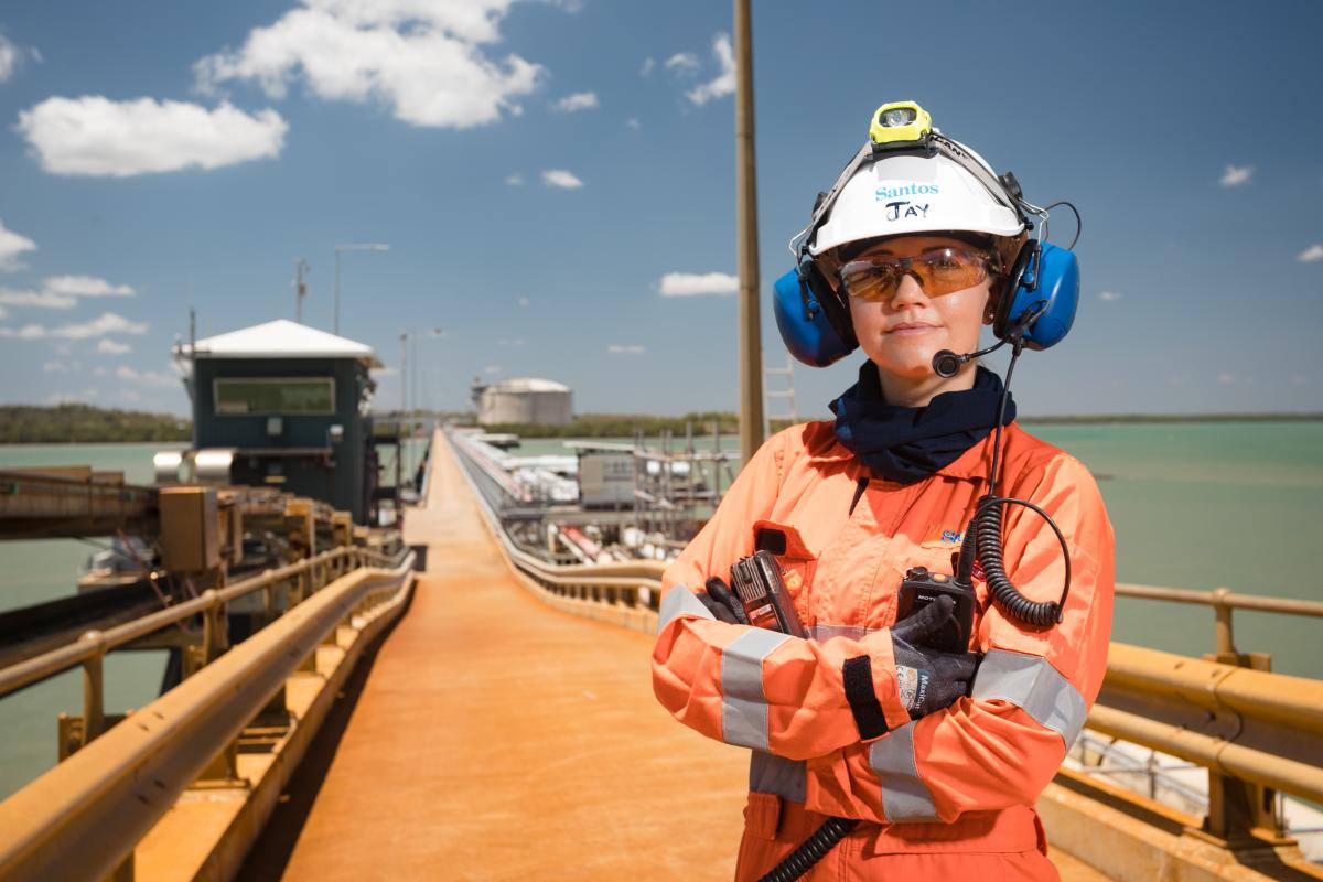 Lady standing on pier in protective work gear