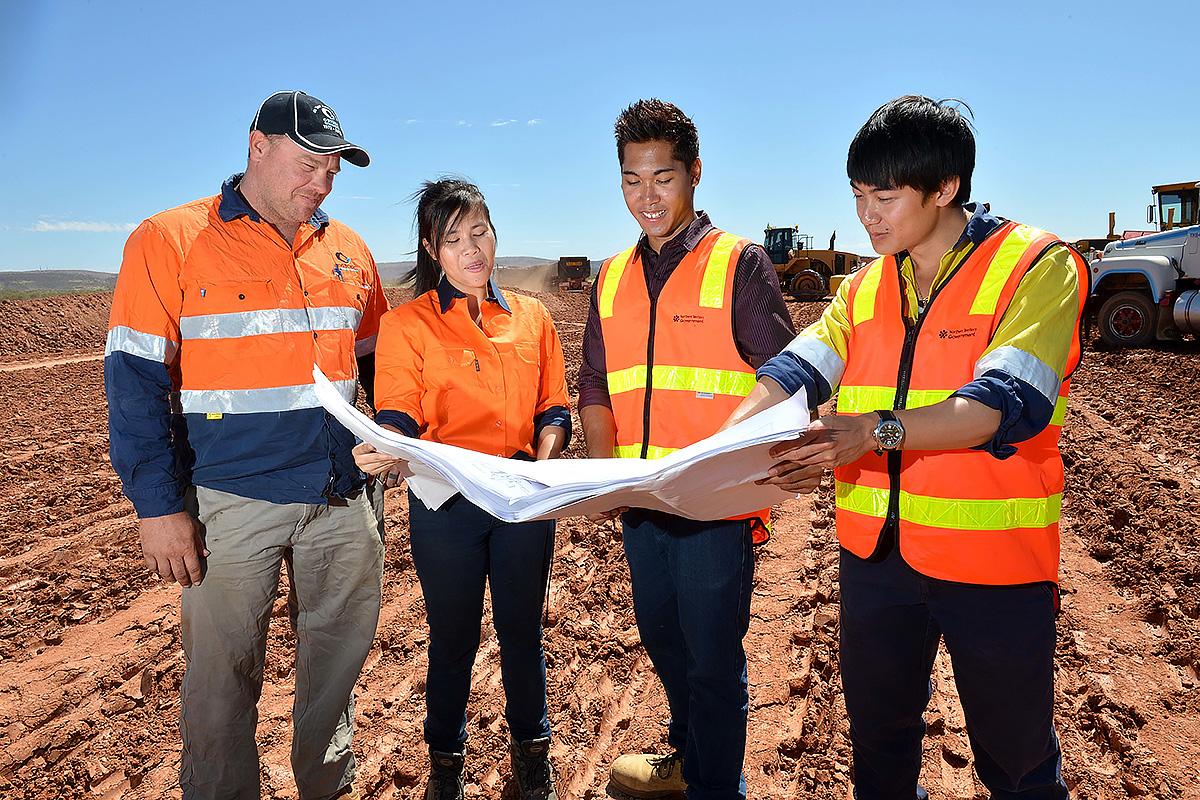 Workers study land management plans