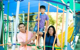 Young migrant family in children's playground
