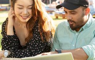 Two students looking at a laptop