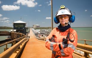 Lady standing on pier in protective work gear