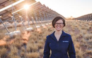 Woman standing in a field of solar panels