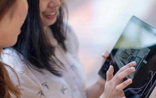 Students viewing property on a tablet