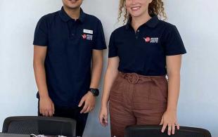 Two people standing at a desk